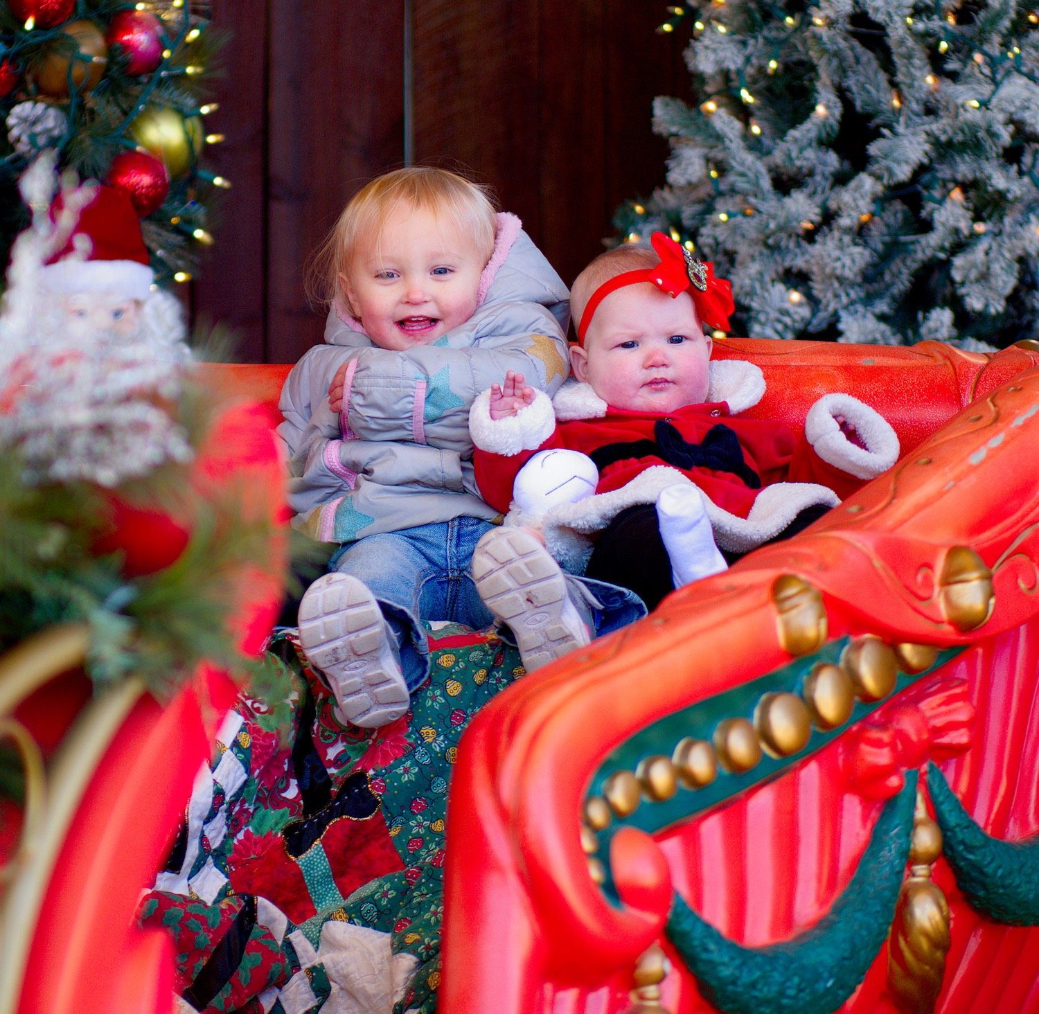 Zoey and Athena pose for a portrait in the holiday diorama on the back porch of the the Mineola Historical Museum. [see some more of Santa's stop]